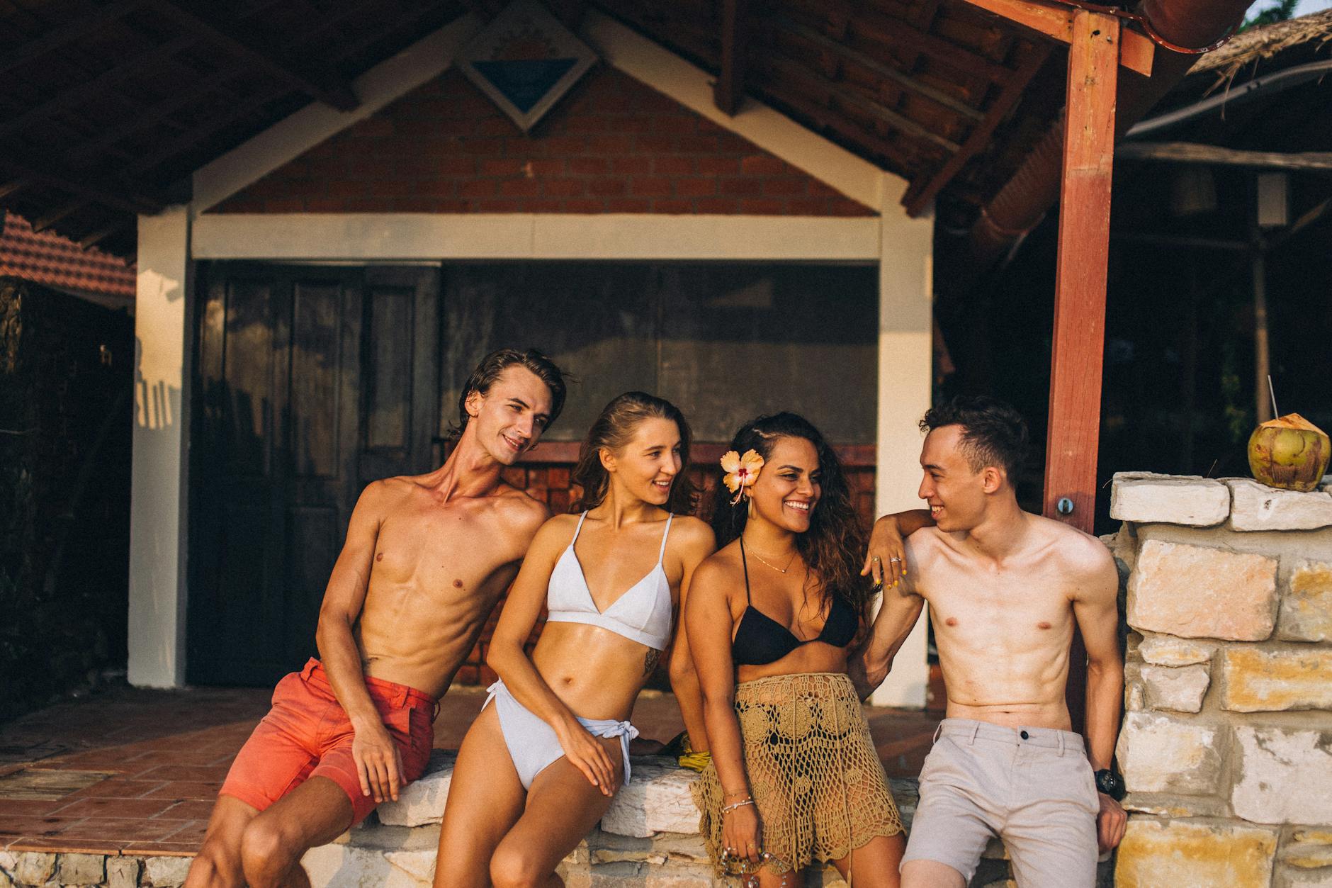 A group of diverse people smiling and posing on a mountain.