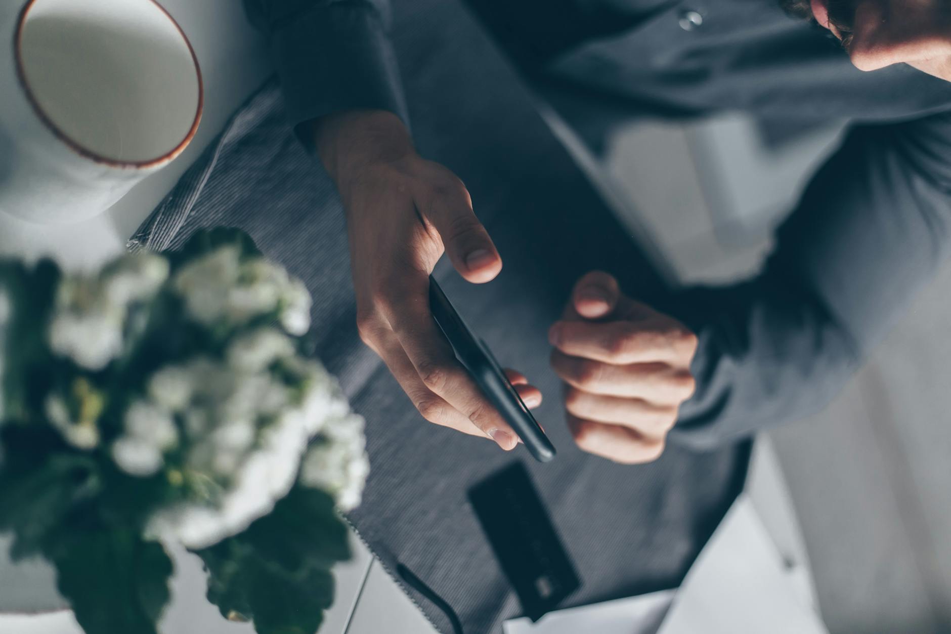 Person Holding Black Smartphone Near Green Vegetable