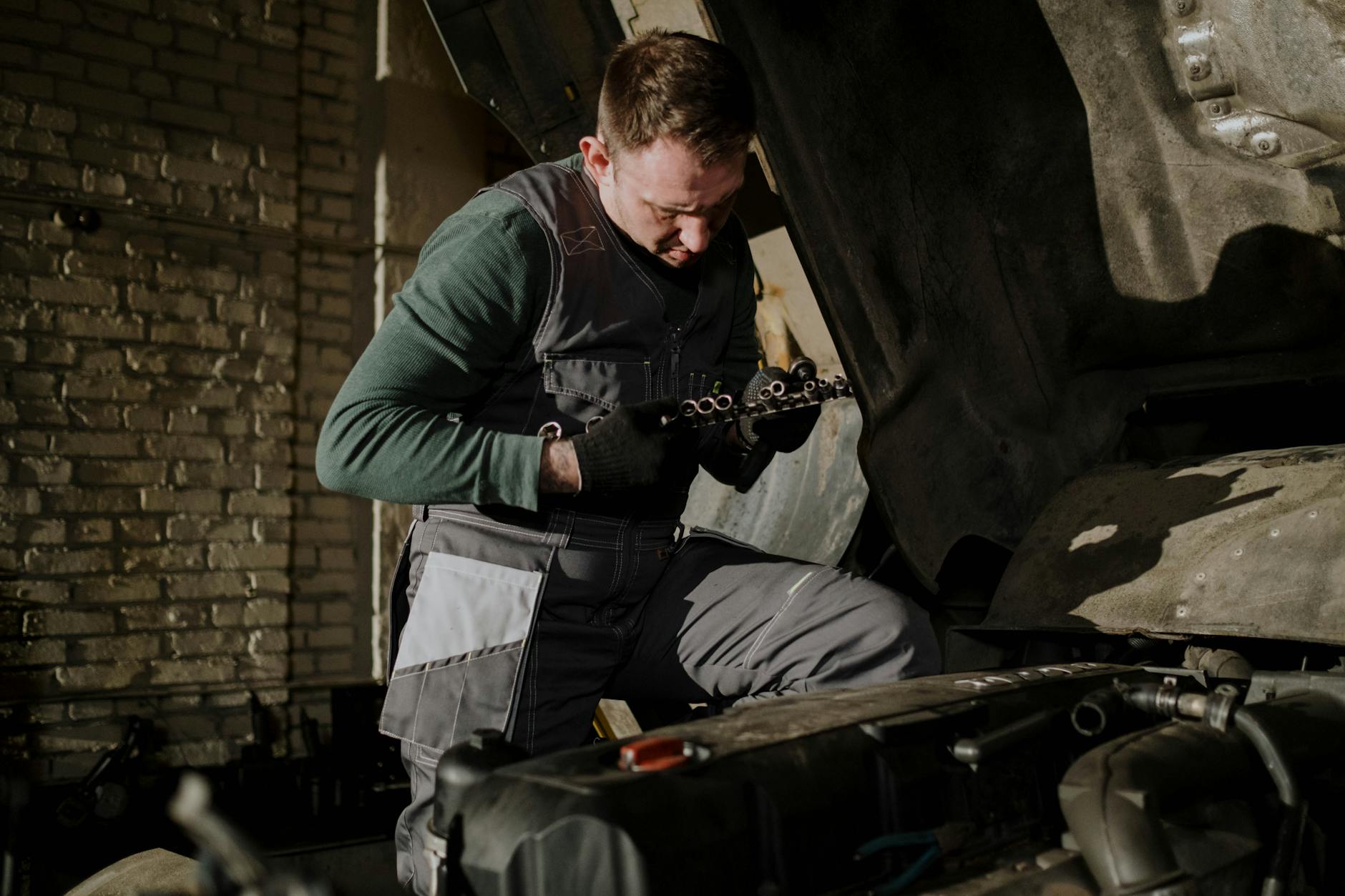 Car Mechanic Repairing a Truck in the Garage