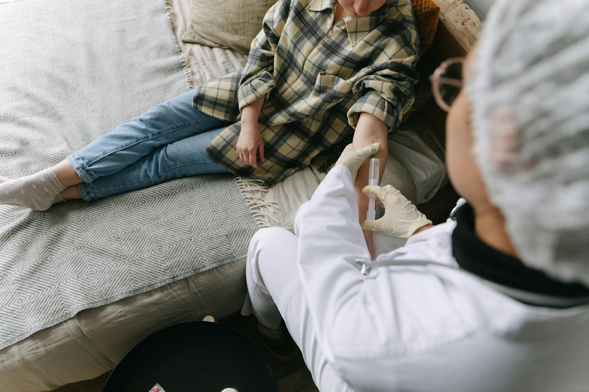 Man in White Pants Sitting on Gray Couch