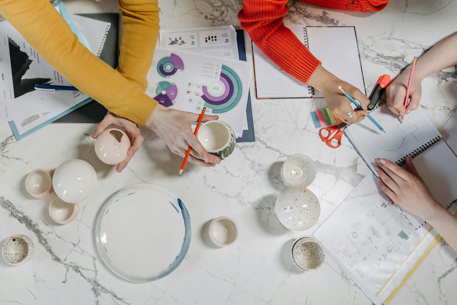 People Holding Ceramic Objects