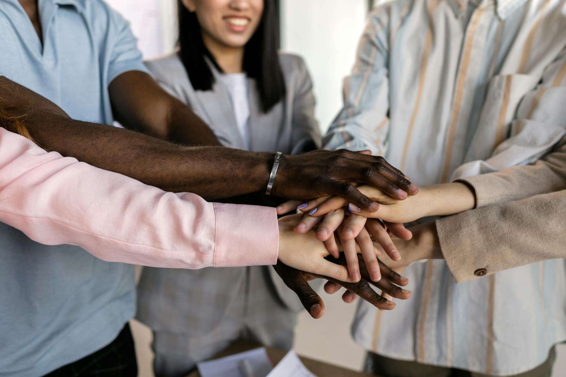 A Group of People Piling Hands on Top of Each Other