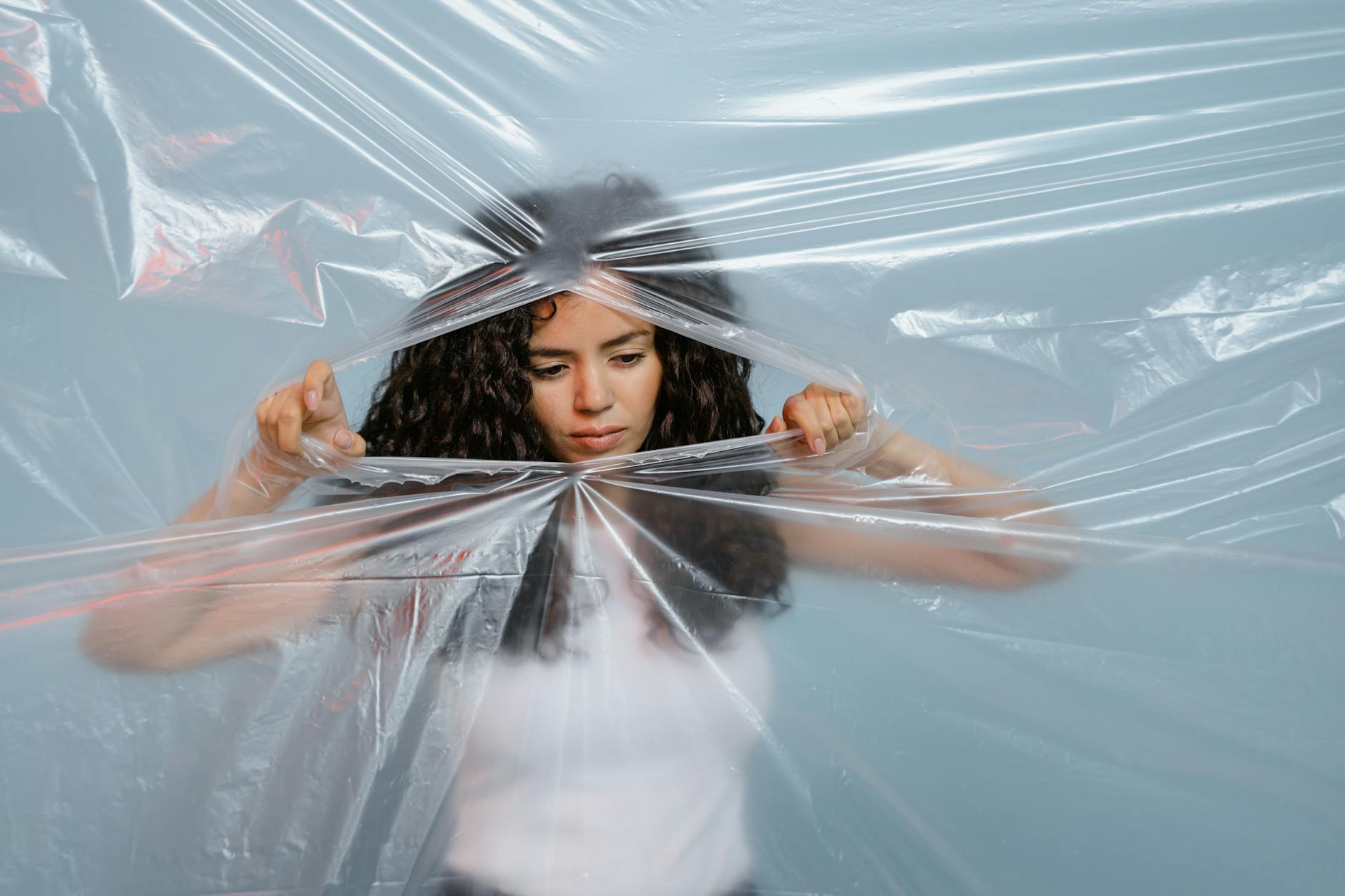 A Woman Tearing a Plastic