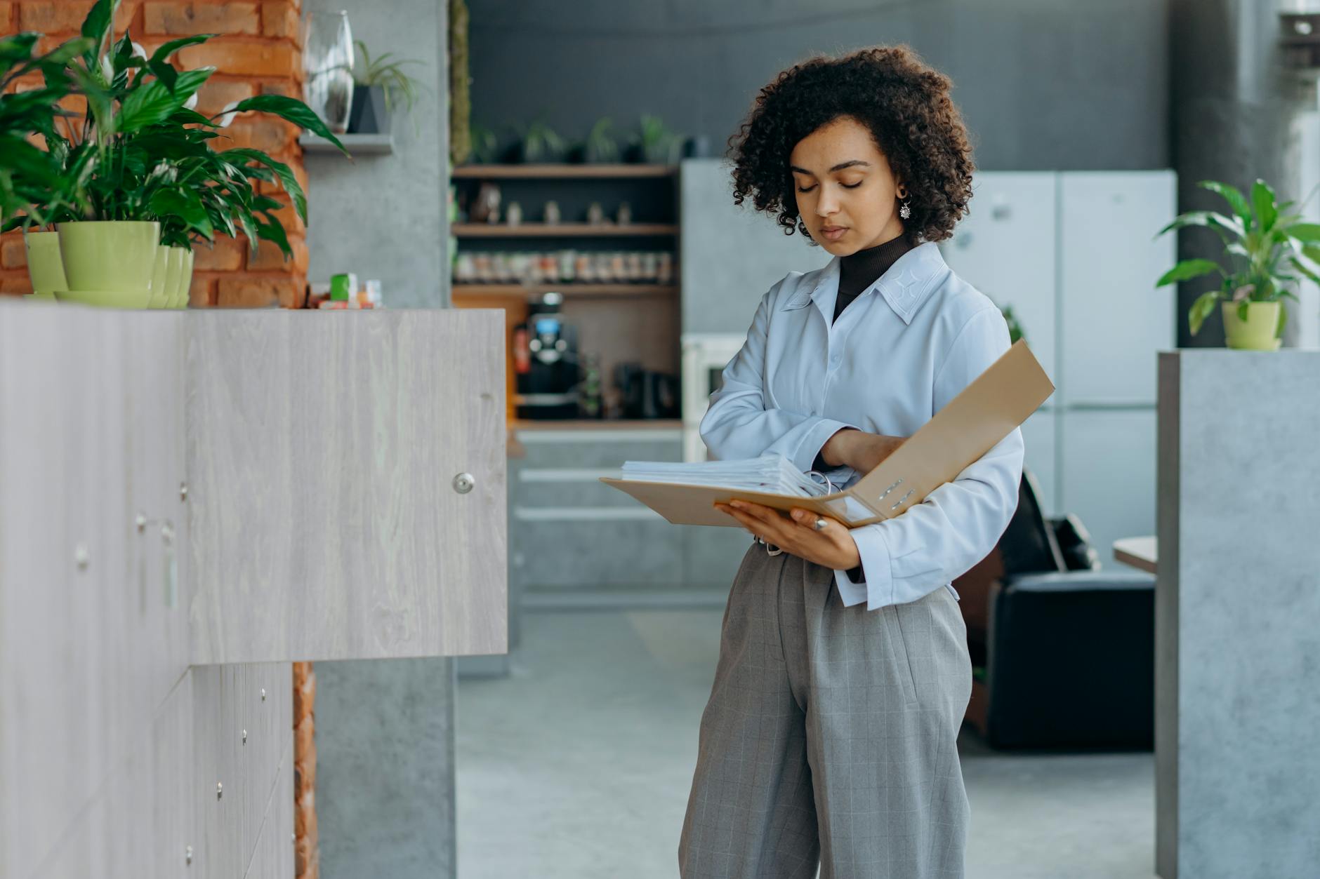 Curly Haired Woman Looking at the Documents