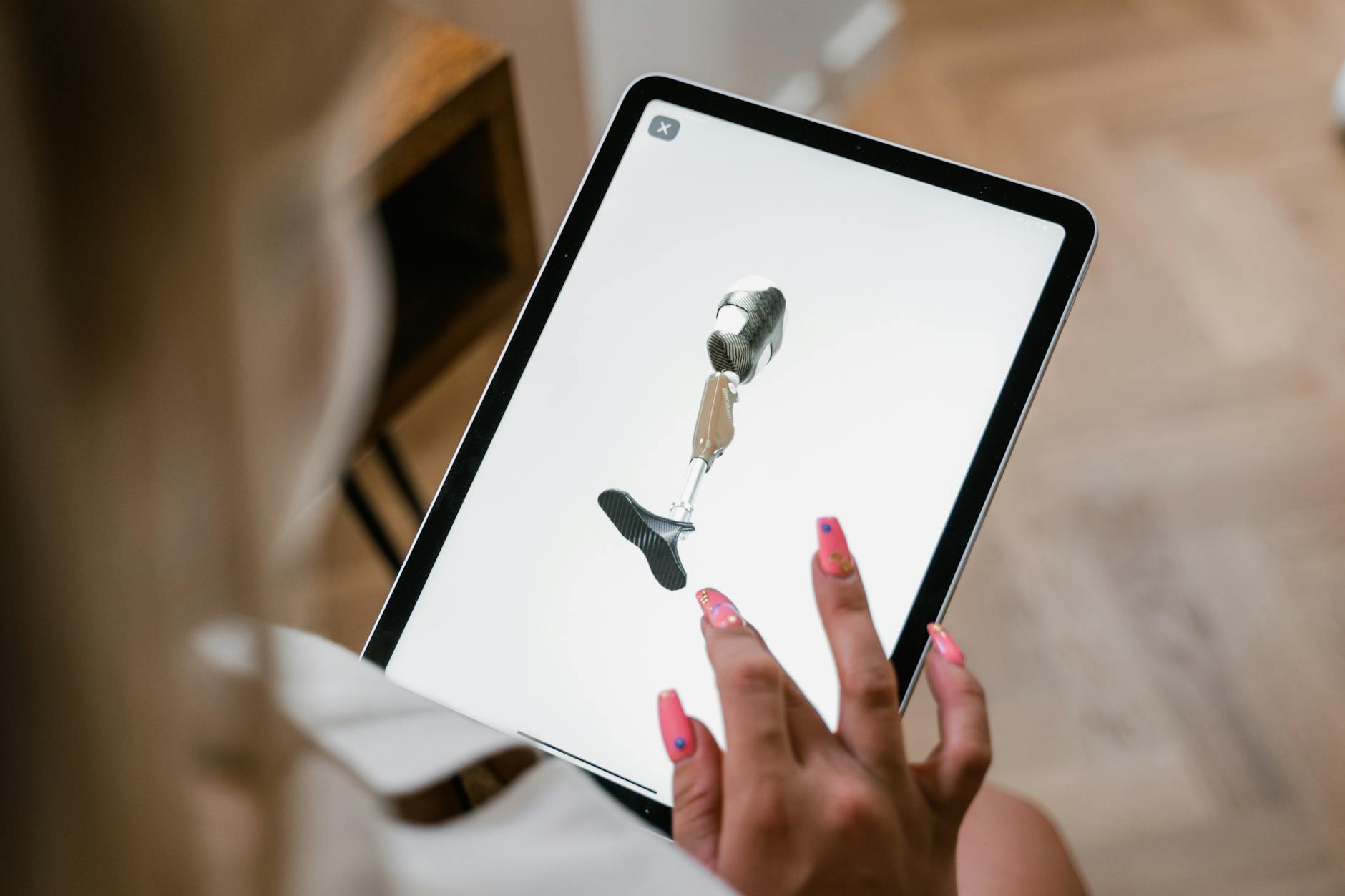 Close-Up Shot of a Woman Looking for Prosthetic Leg using an Ipad