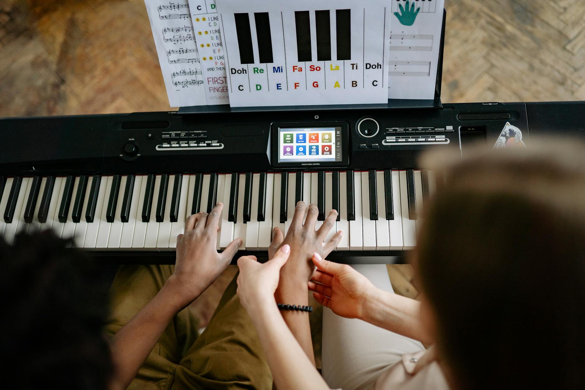 Person Learning How to Play Piano