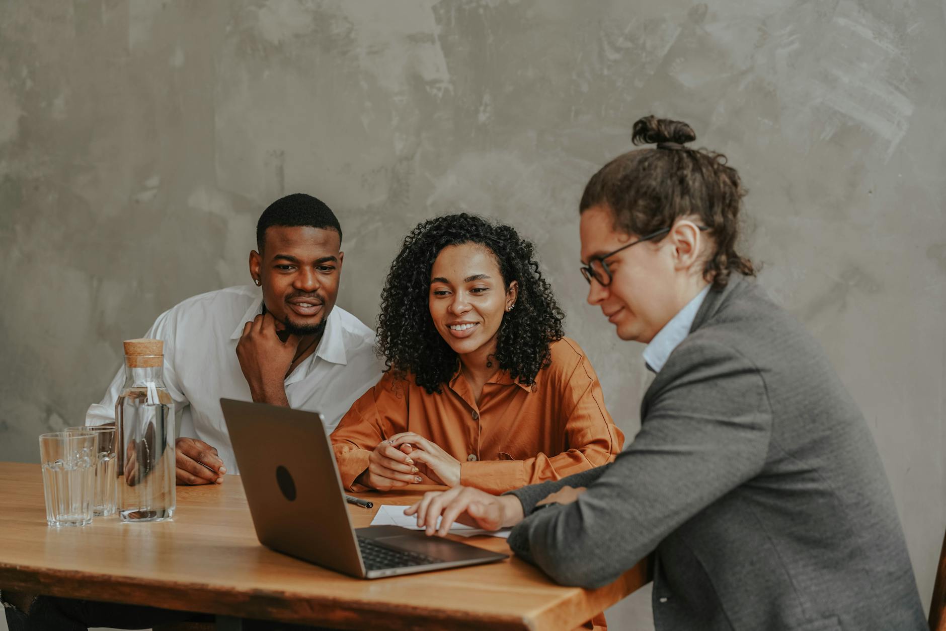 A Man and a Woman Looking at a Person's Laptop