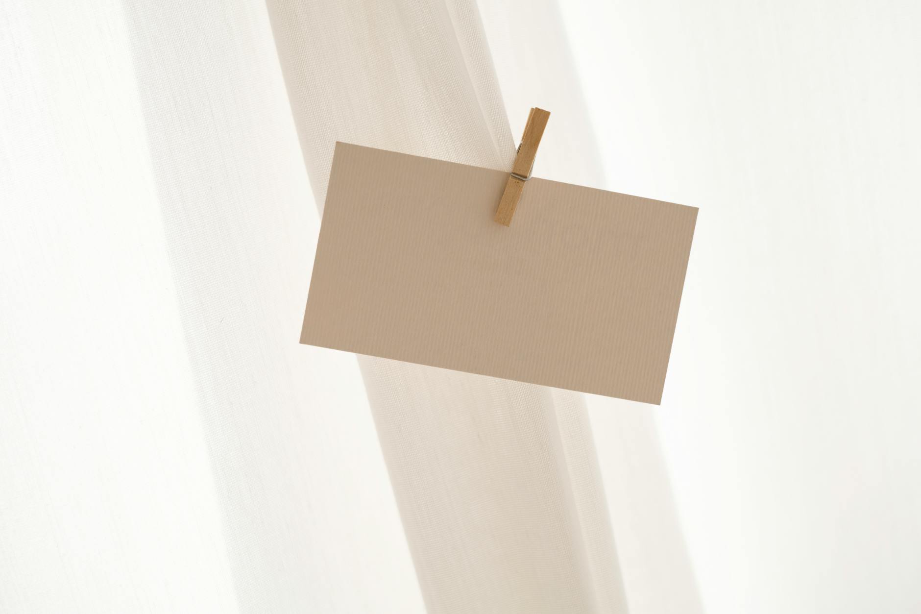 A close up of sturdy-looking brown paper held together with a clothespin