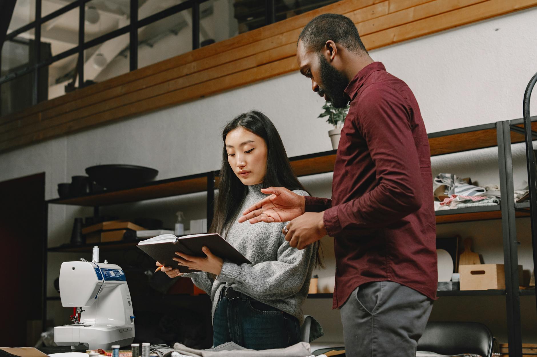 Man and Woman Looking at a Notebook