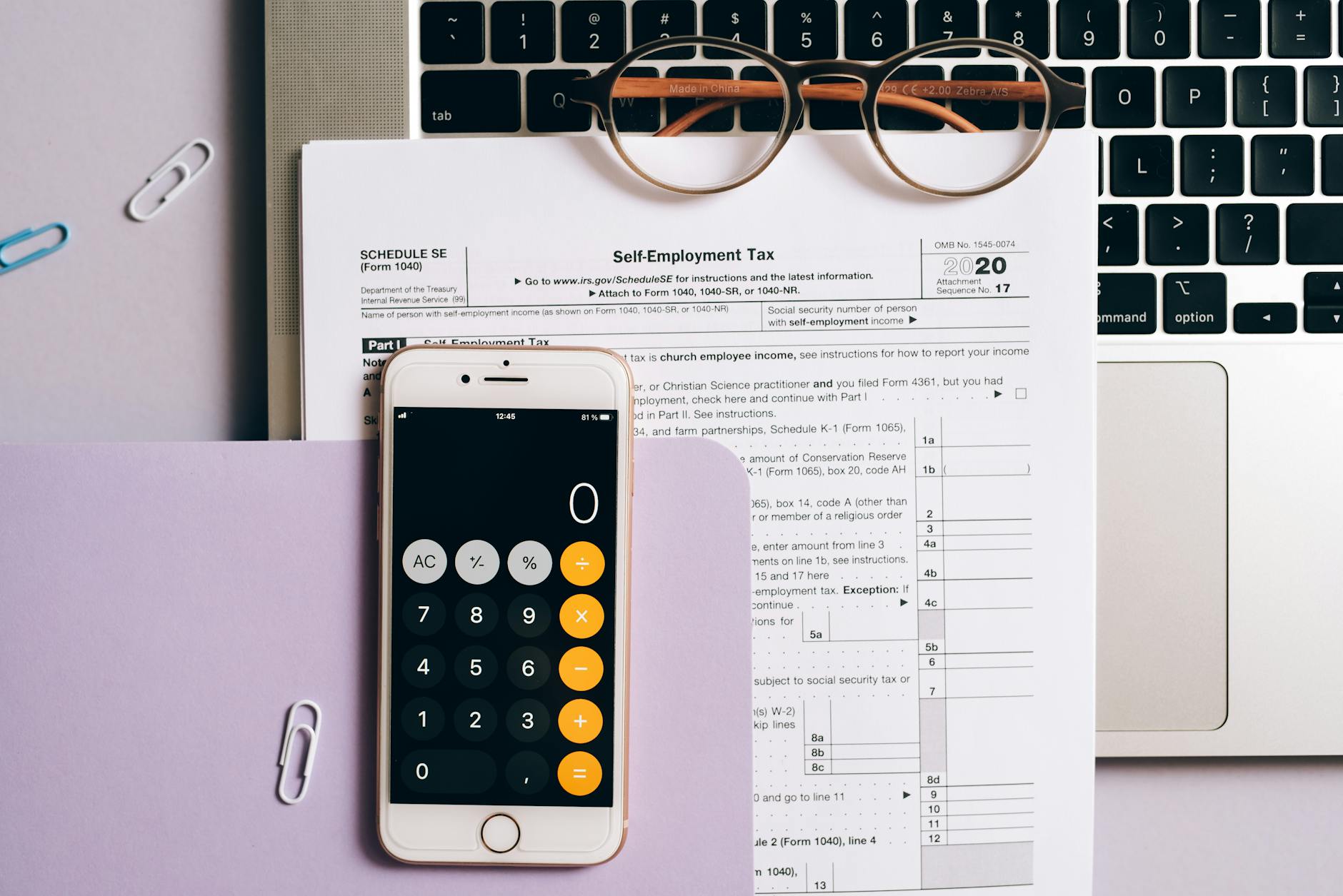 A Smartphone with a Calculator App over a Tax Document