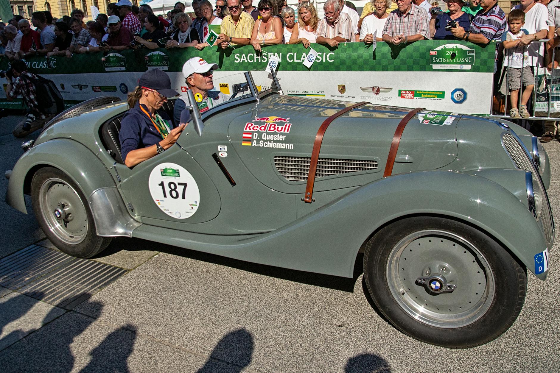 People in a Gray Convertible Car