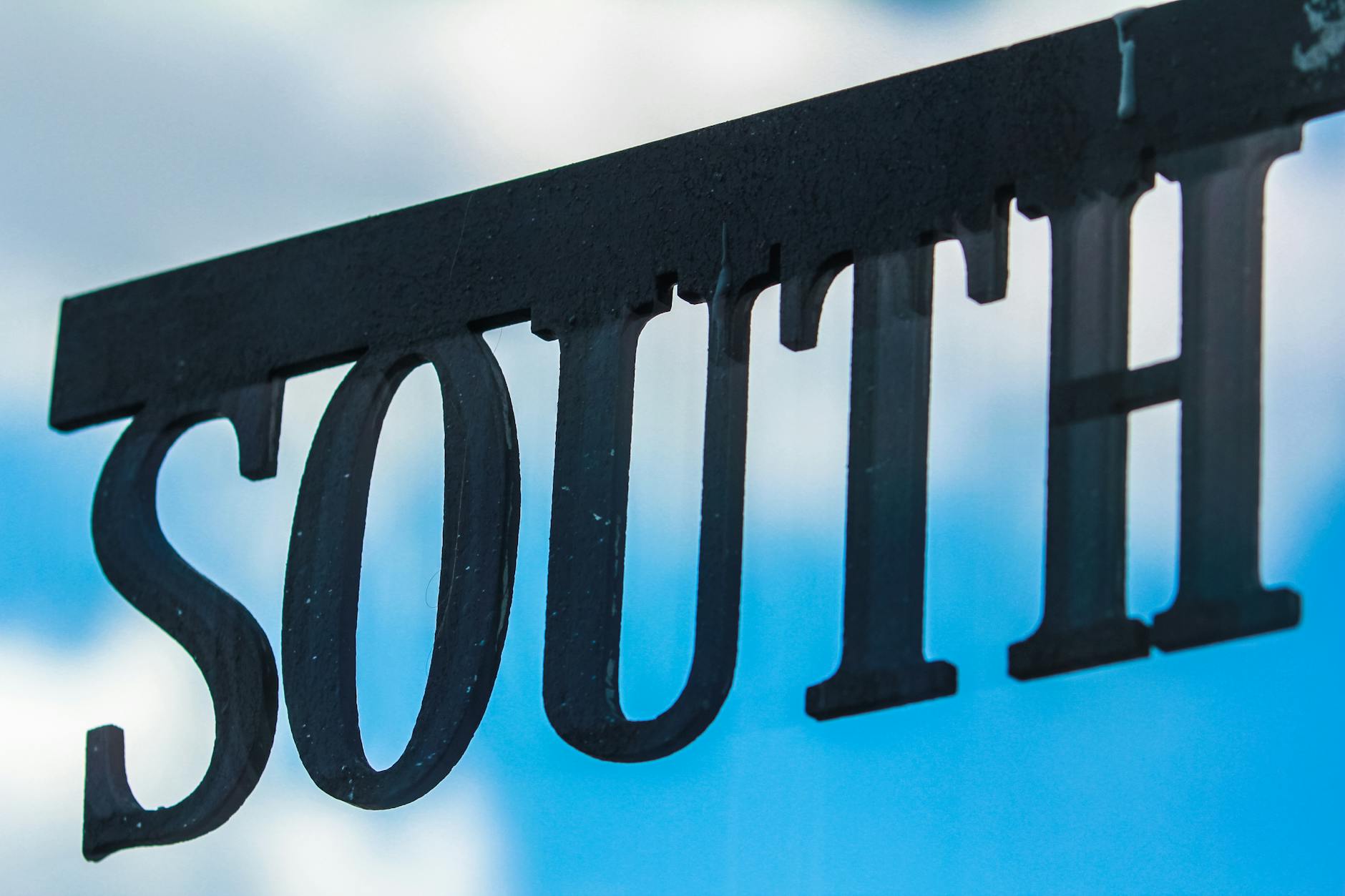 Selective Focus Photography of Black South Signage